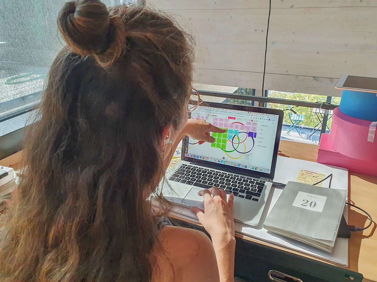 woman looking at computer showing ikigai online workshops