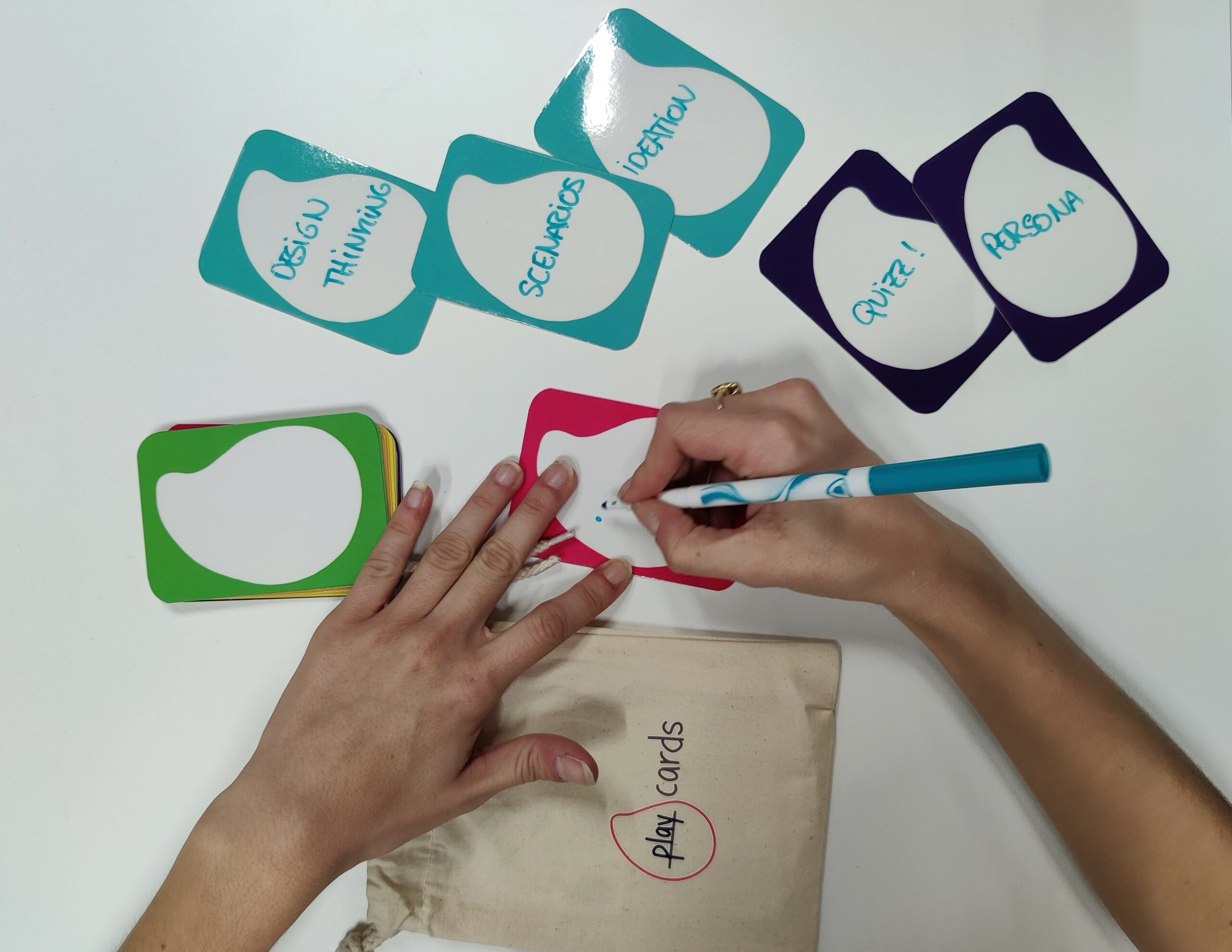 someone writing on erasable play cards playful benefits of play