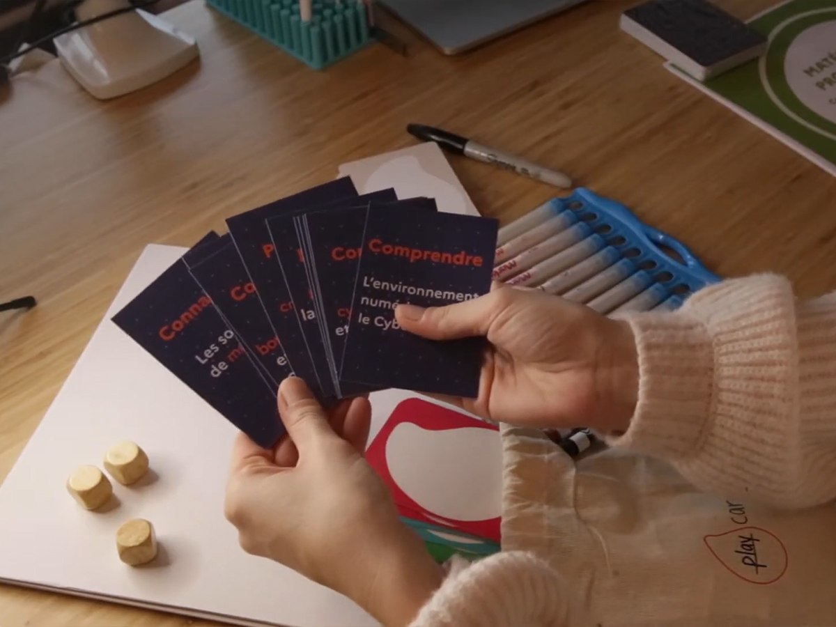 hands holding playing cards for facilitation